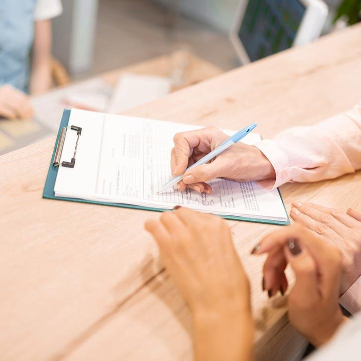 Patient filling out dental insurance forms