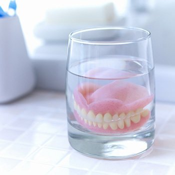 Dentures in Long Beach soaking in solution